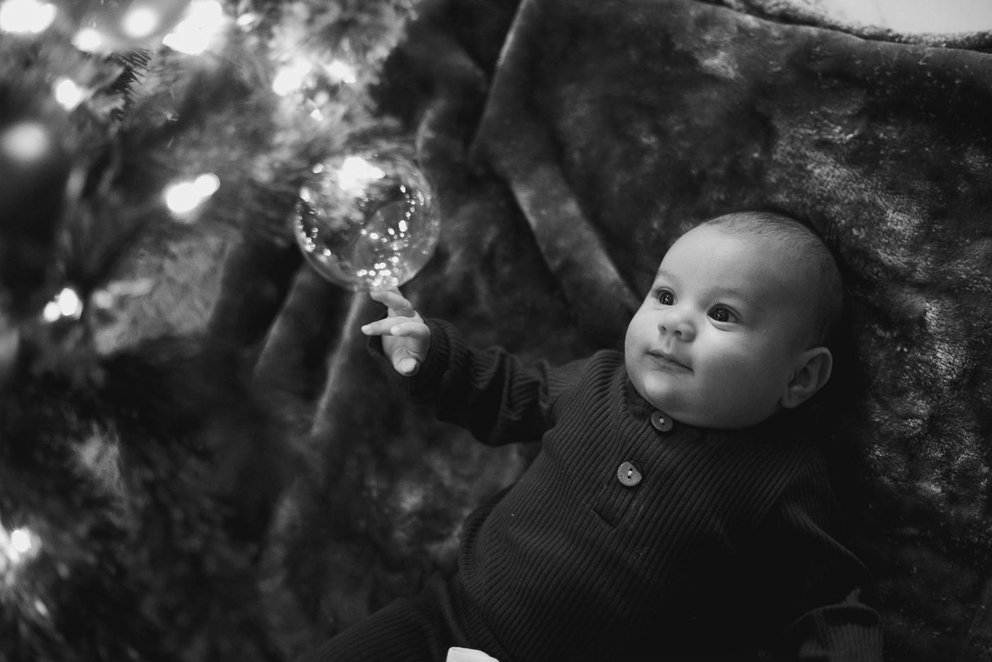 Little wonder: Baby’s first Christmas by the tree.