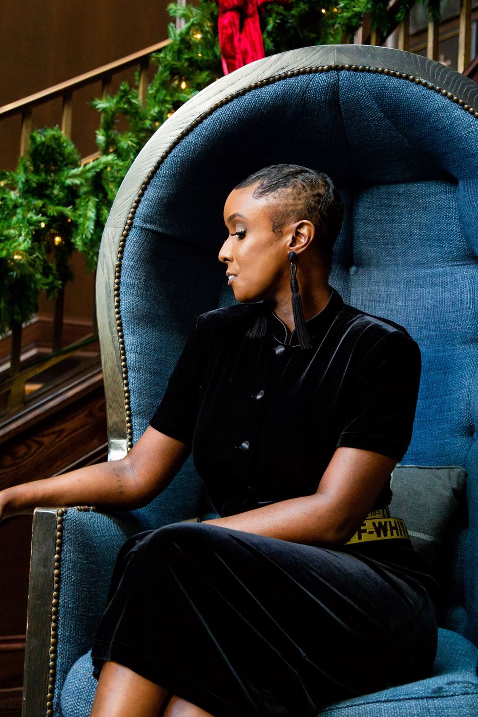 Profile portrait in a blue chair