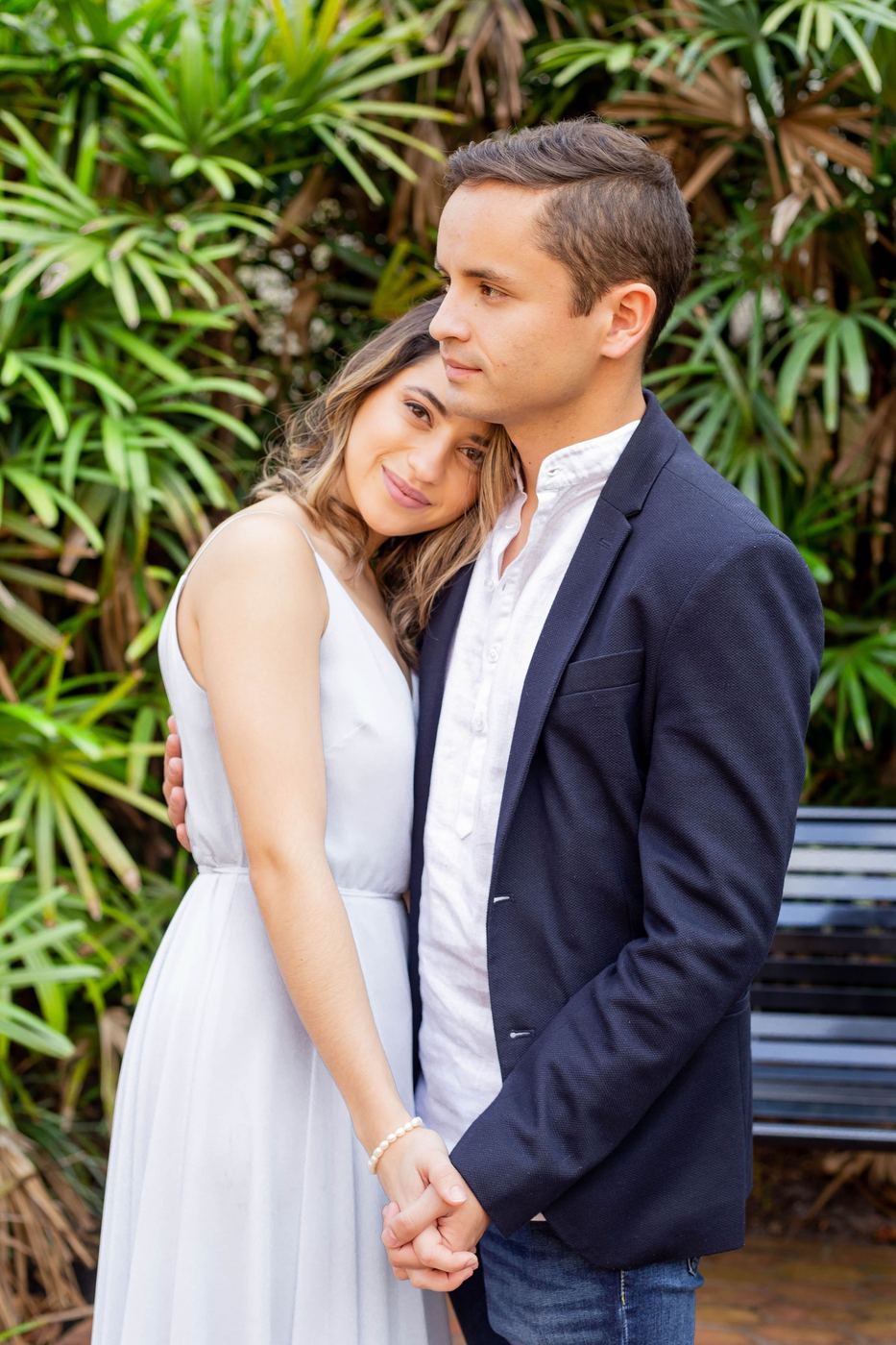 Couple embracing in front of palms