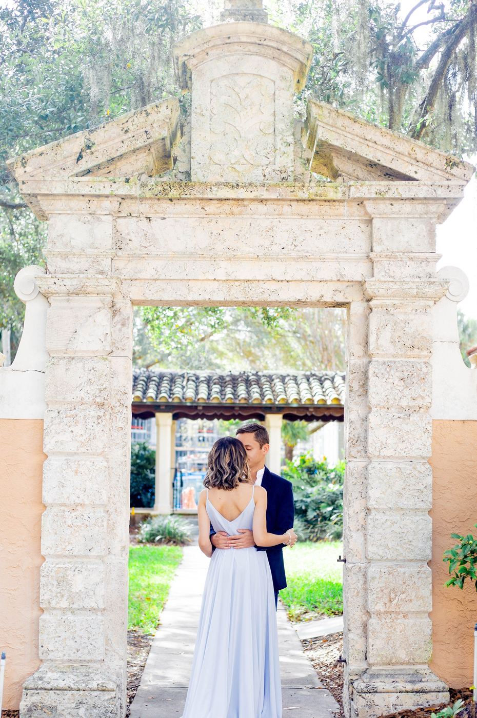 Couple embracing under a stone archway