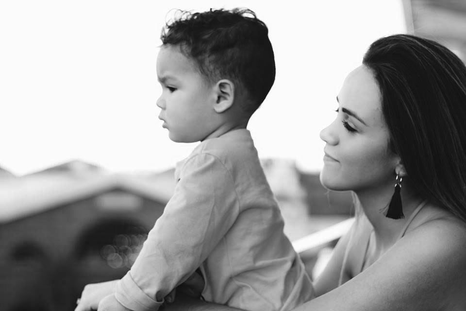 Mother and son looking out together