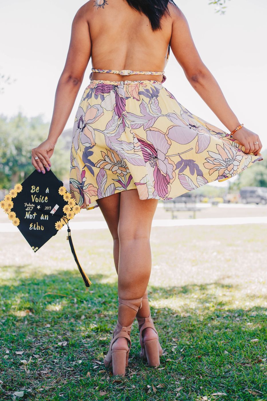 Graduate holding her decorated cap