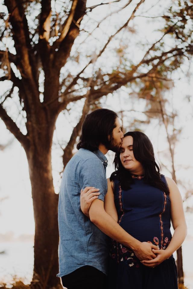 Maternity couple under a tree
