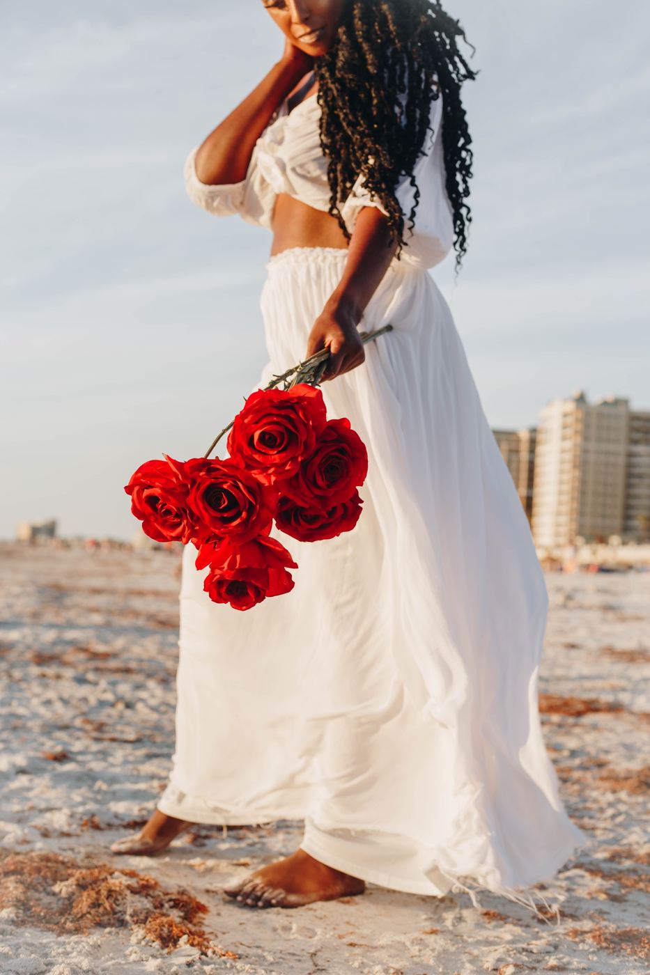 Detail of red roses and a white dress