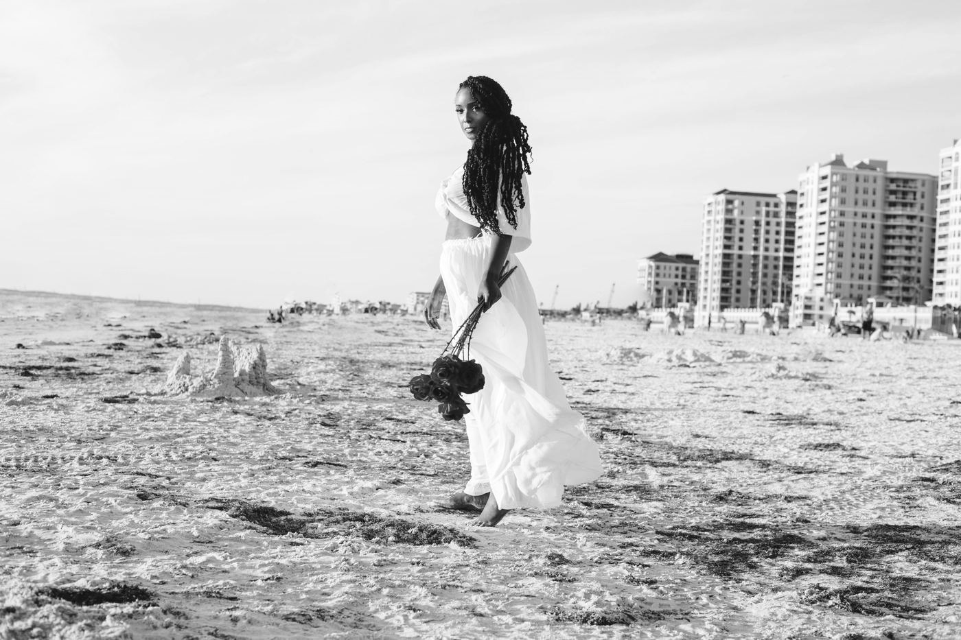 Walking the beach with red roses