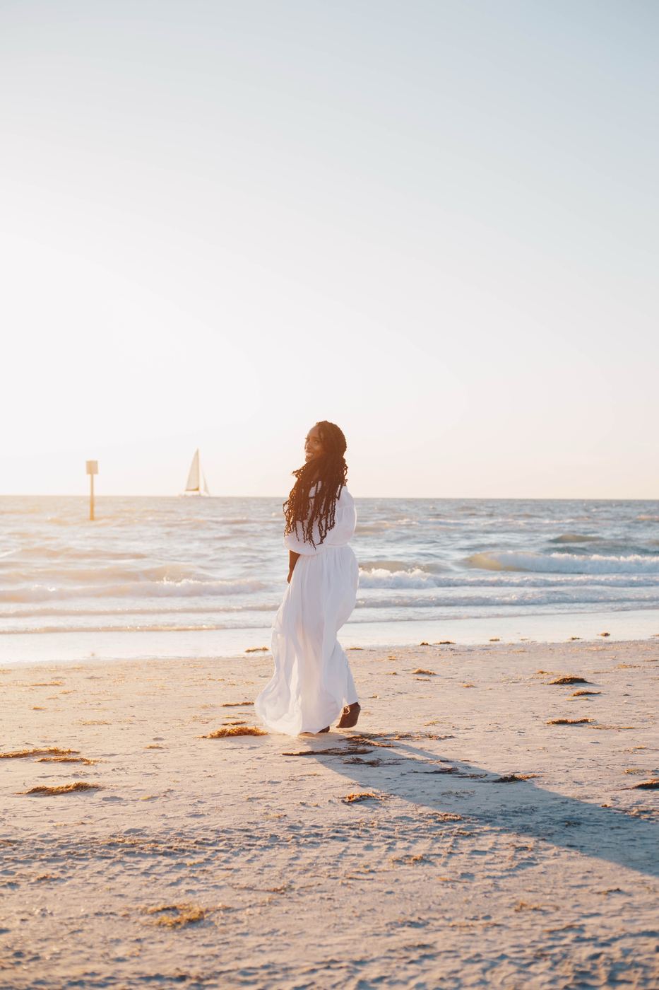 Beach portrait with a sailboat