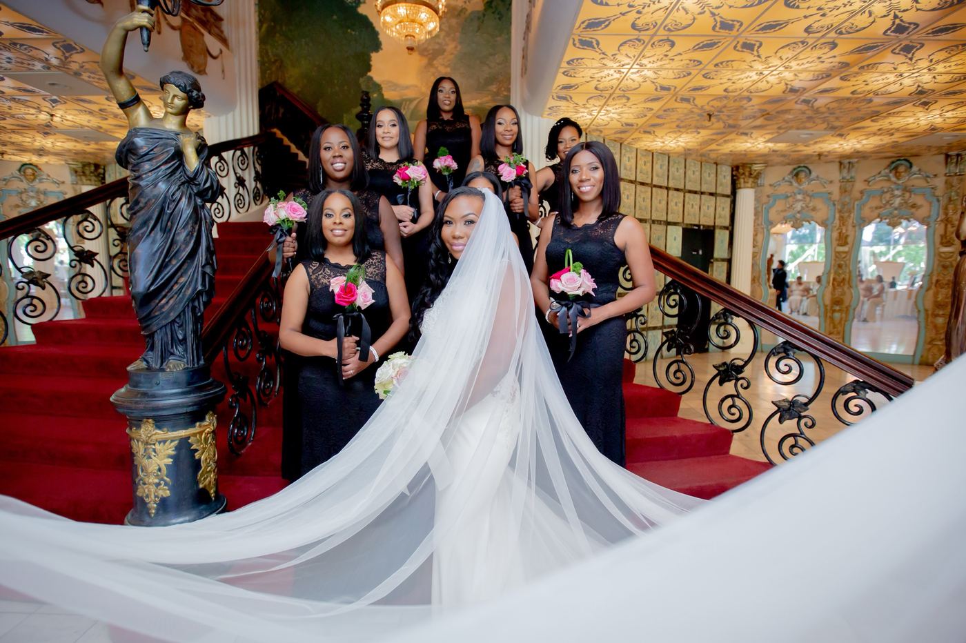 The bridal party: A grand staircase, a cathedral veil and her closest friends.