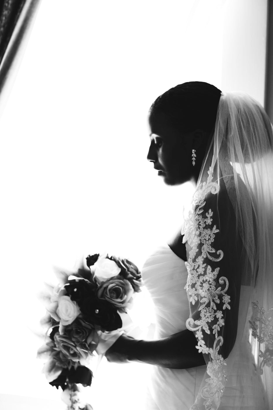 Bride in silhouette by the window