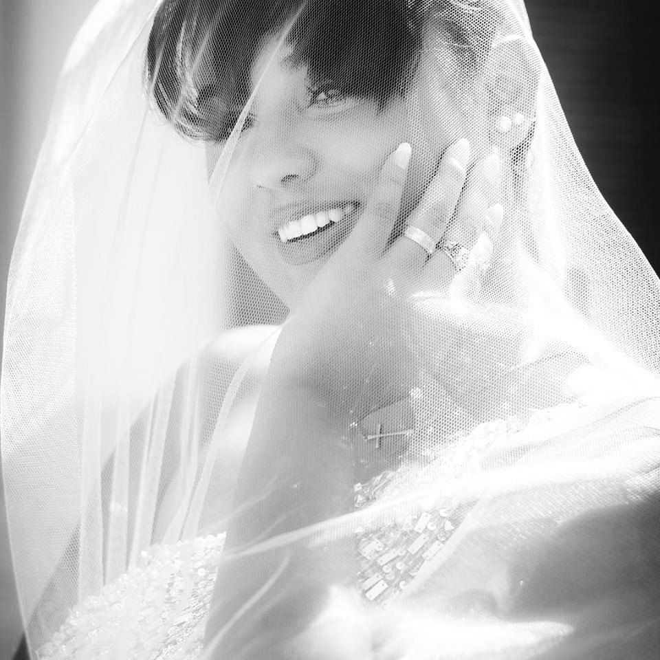 Bride smiling under her veil