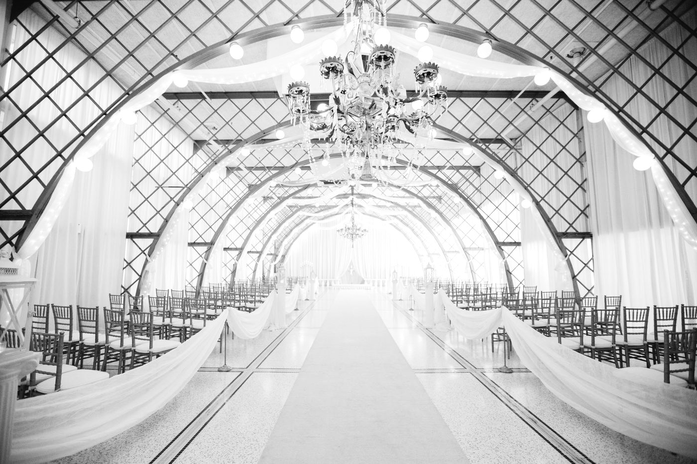 Ceremony space with arches and chandelier