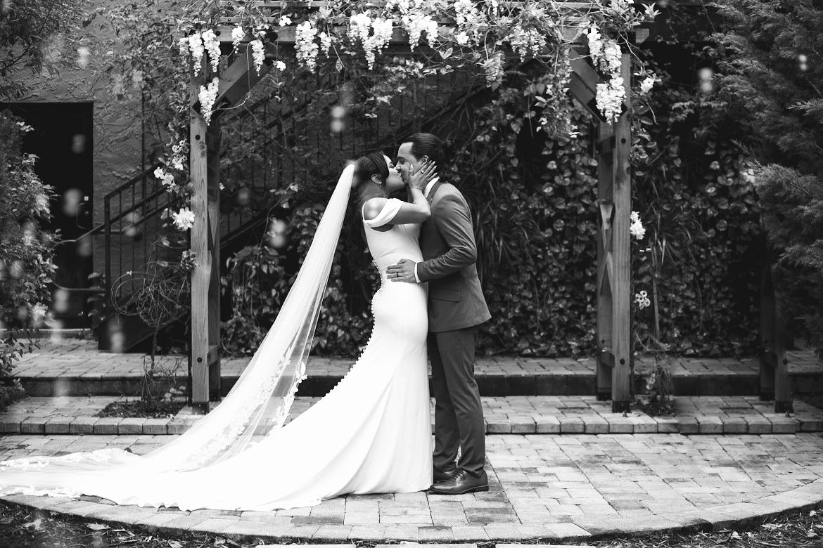 First kiss under a wisteria arbor