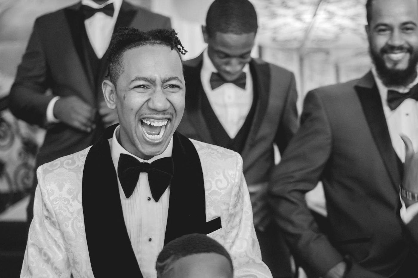 Groom laughing with his groomsmen